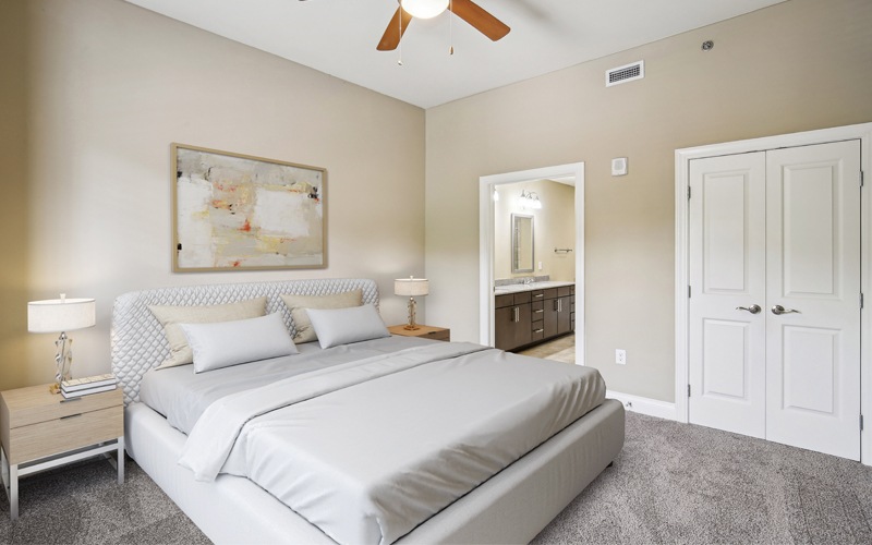 bedroom with a large bed and a fan